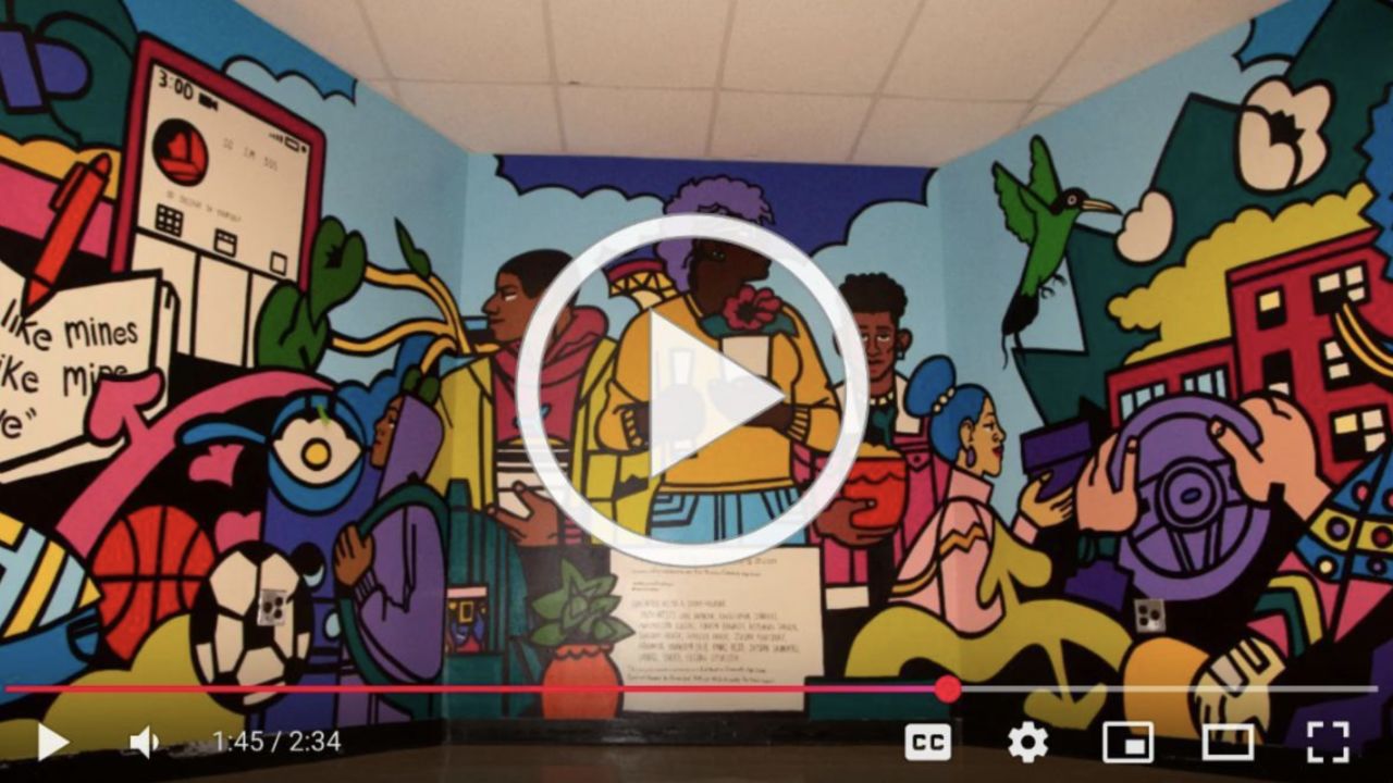 Groundswell 2025 School Murals Video Thumbnail; photo of school mural with variety of colors and people doing community tasks 