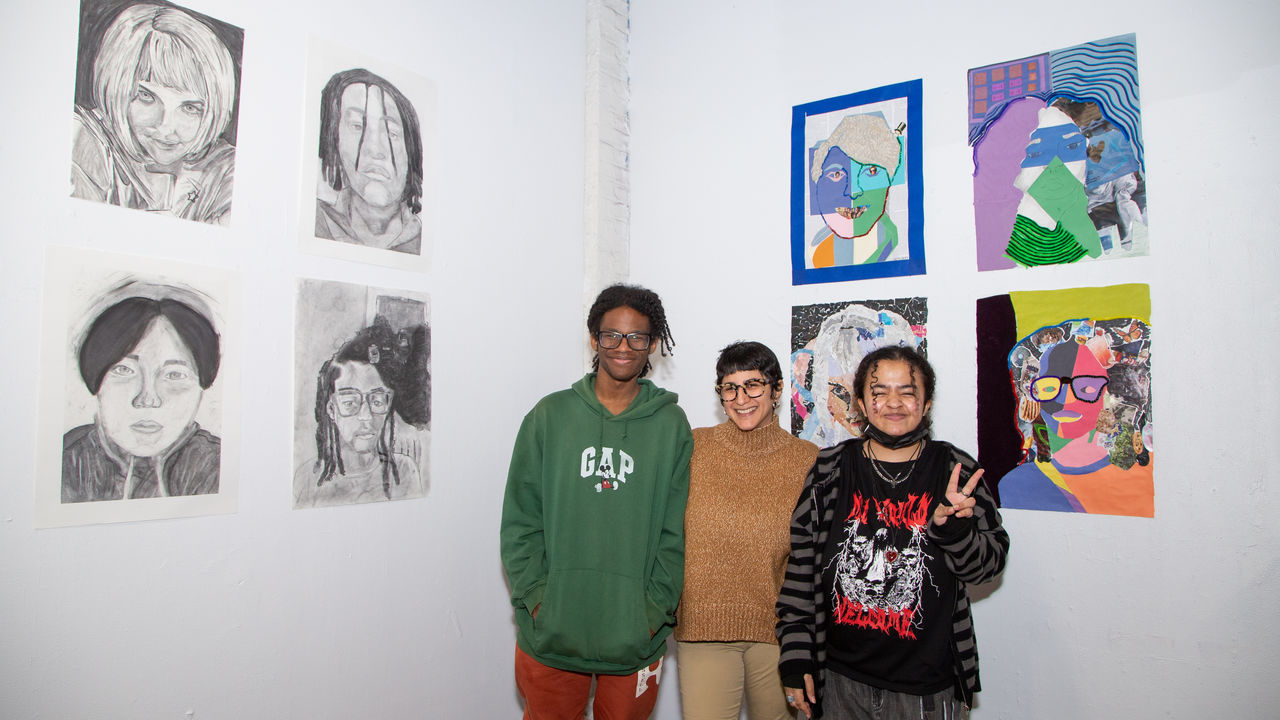 Group photo of teacher and artists with finished artwork 