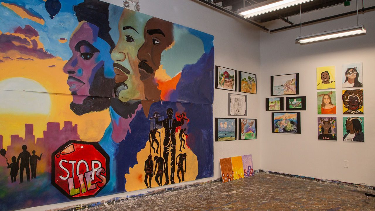 Various artwork displayed on the wall