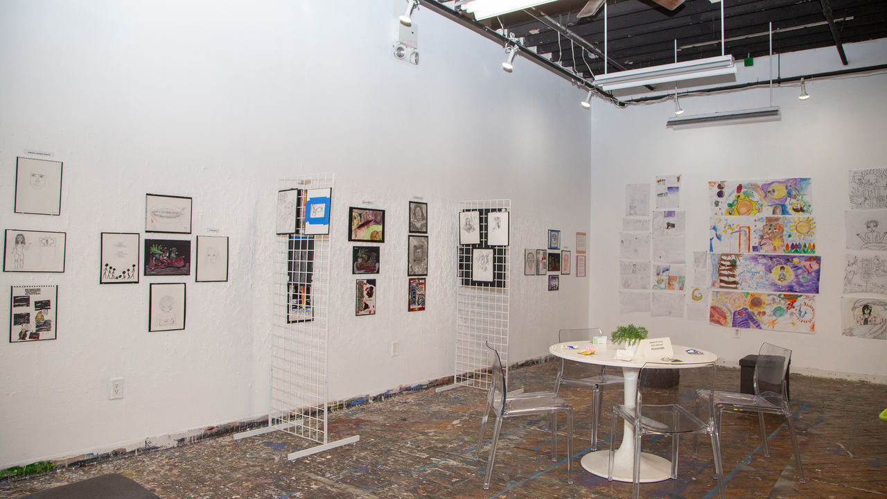 Various artwork displayed on wall 