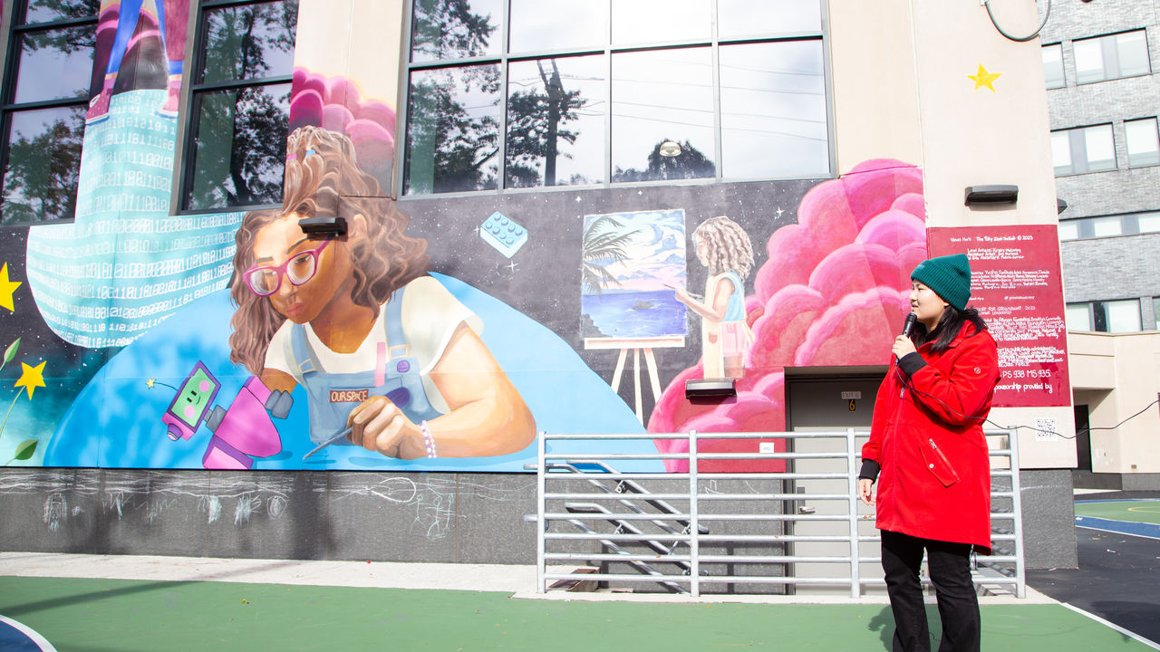 Presenting talking about mural that is displayed