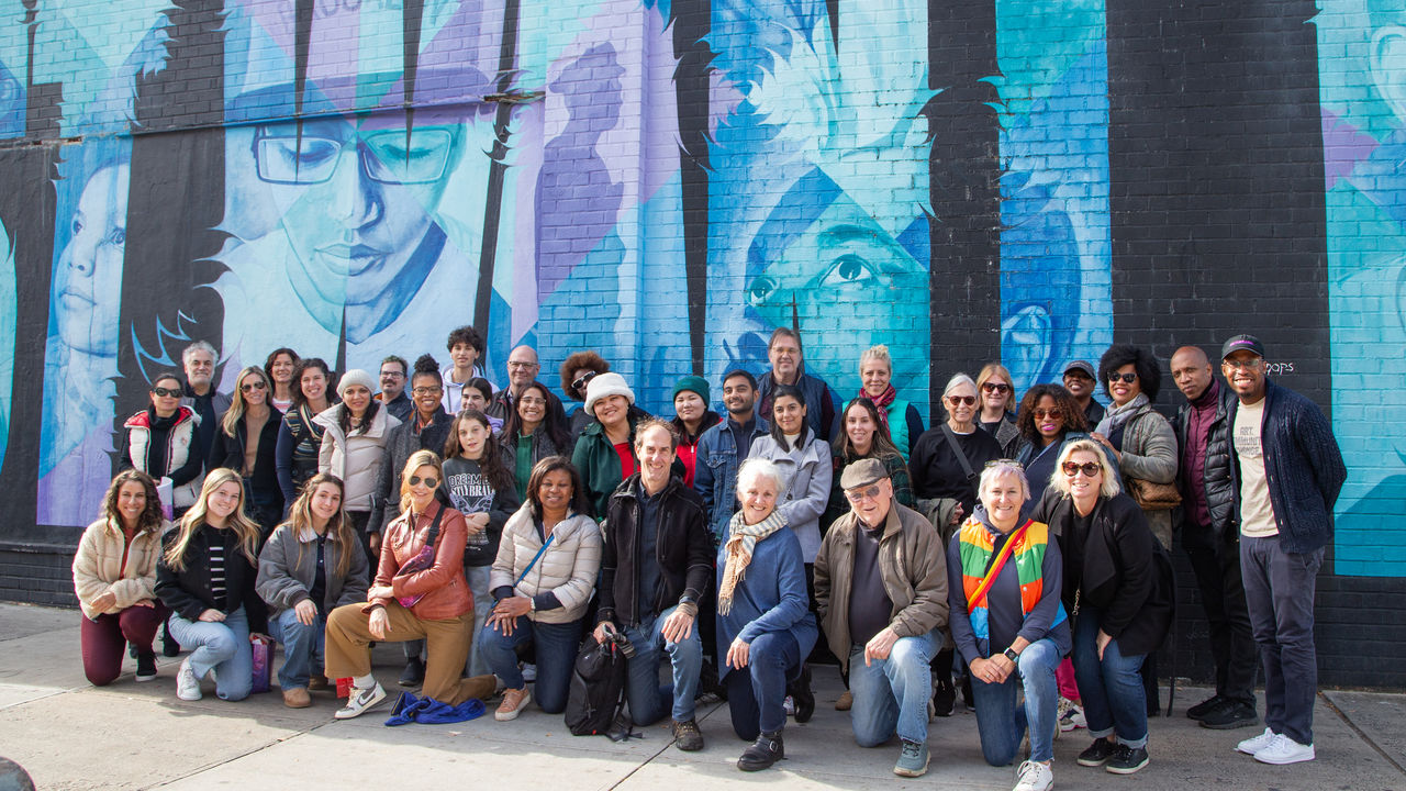 Group photo in front of artwork 