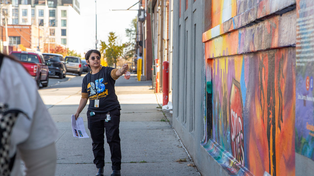 Presenter talking about mural on the wall
