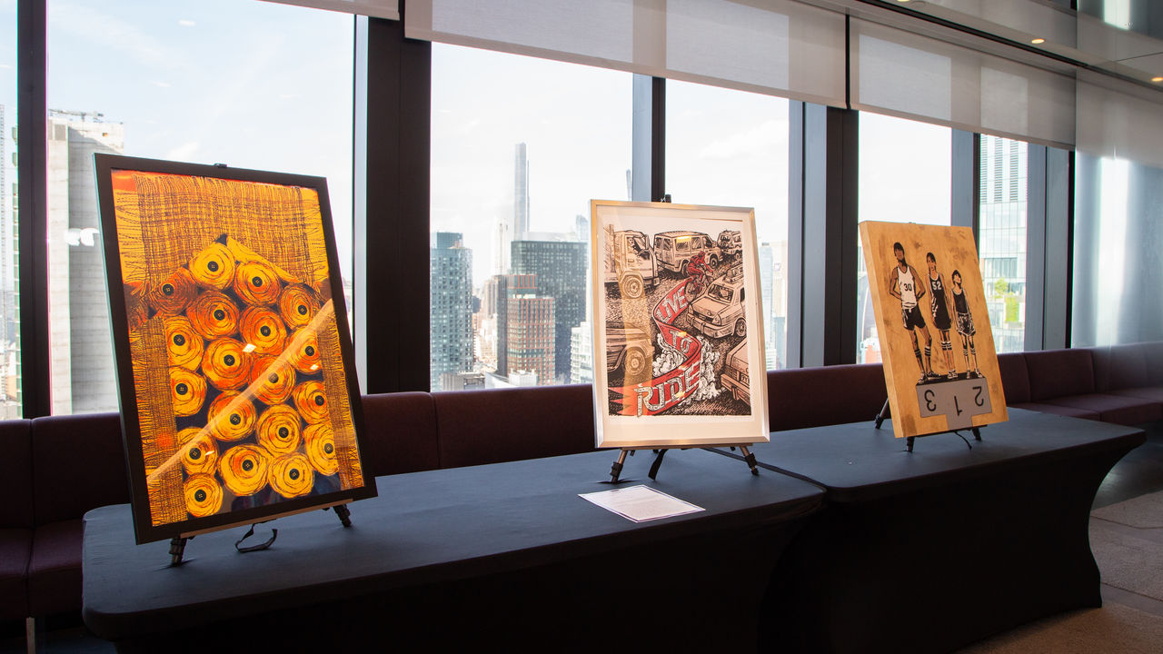 Three pieces of artwork on display in frames