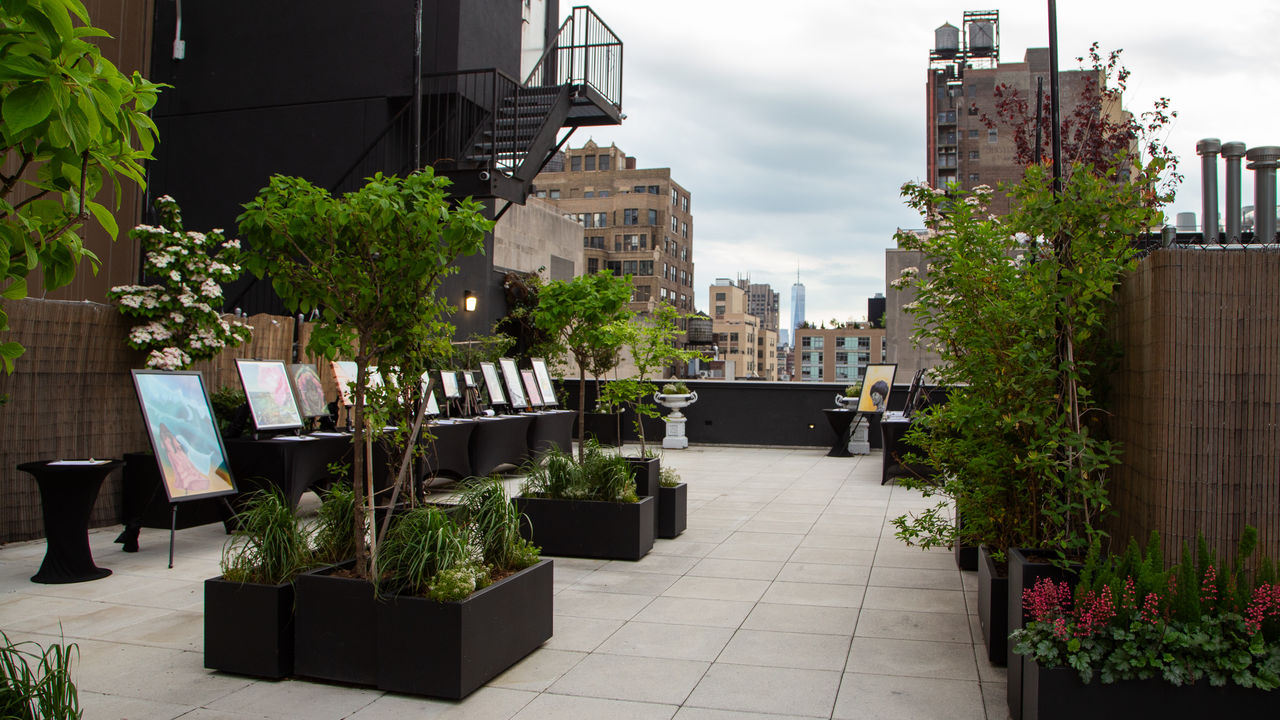 Wide shot of party space with nature and views and look at artwork on display 