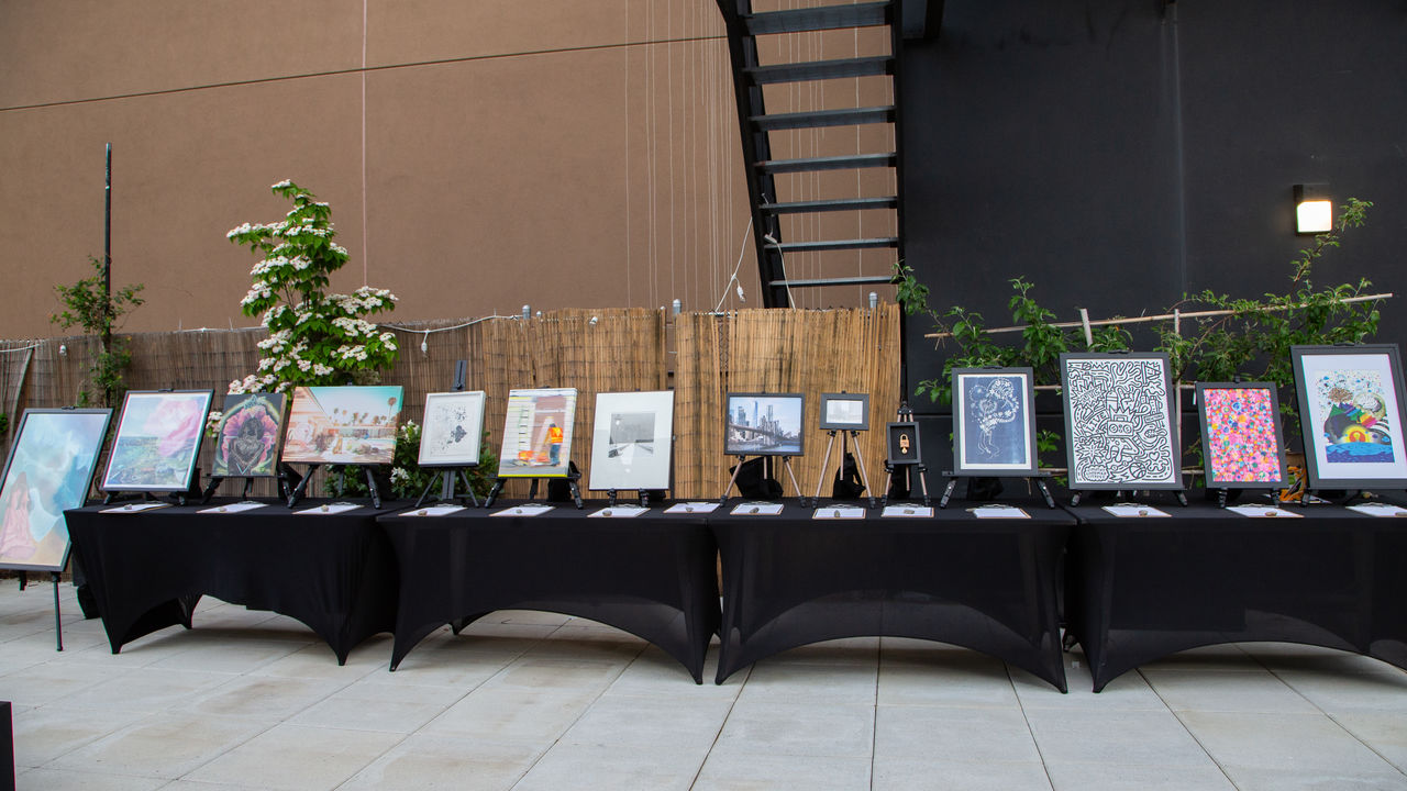 Various artwork displayed in frames on a table 