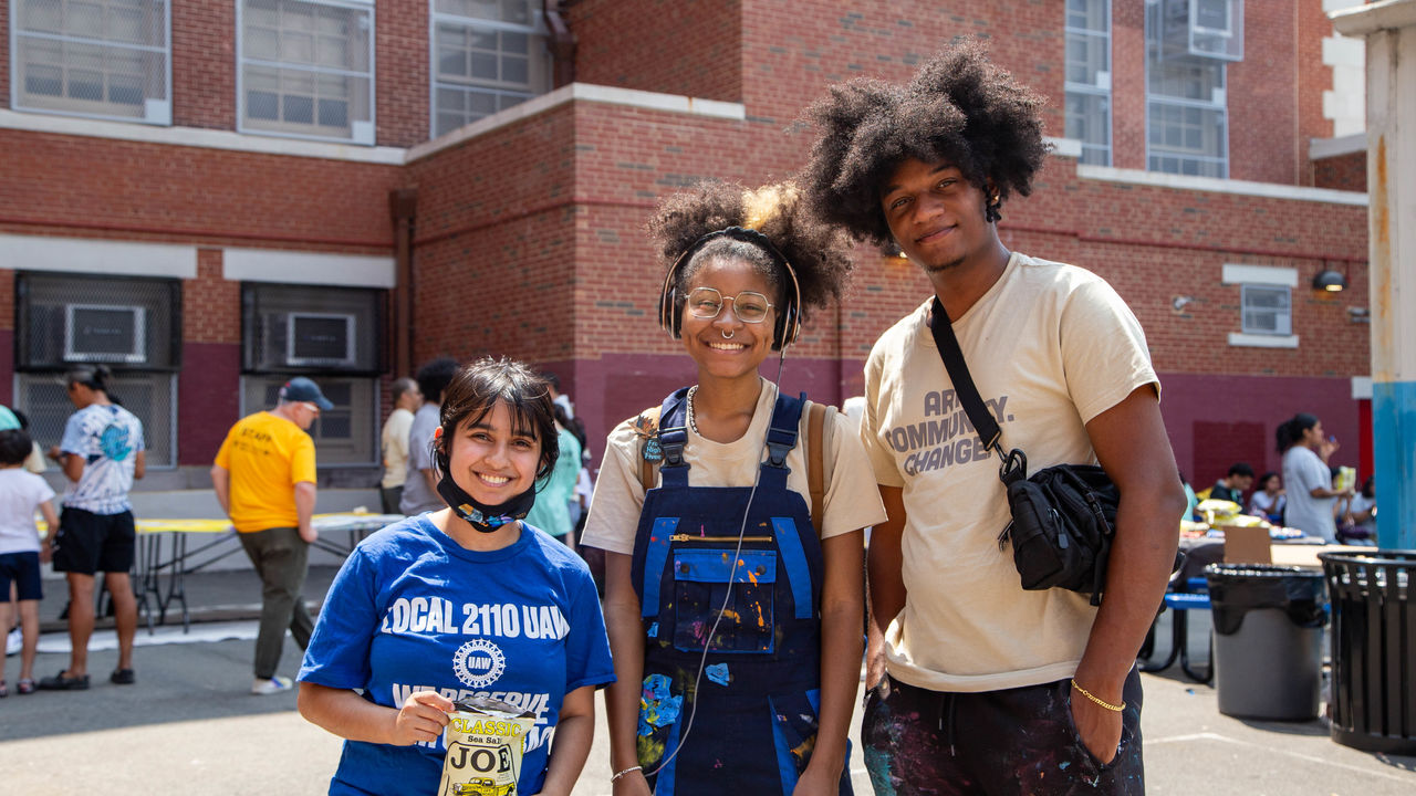 Group photo of a student and two teachers 
