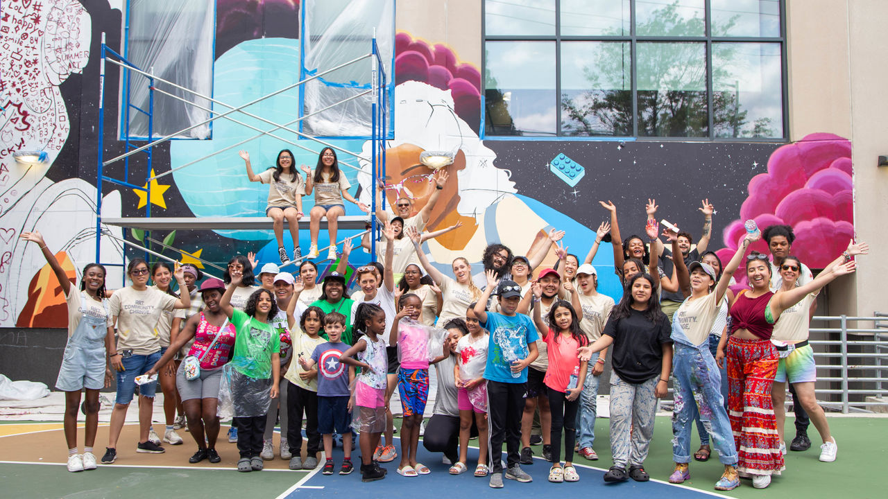 Group photo of people who attending the paint day cheering.