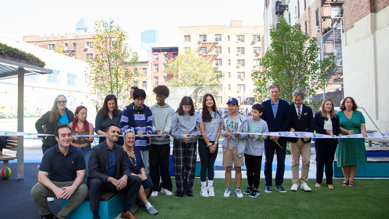 Group photo of people doing ribbon cutting for the new mural. 