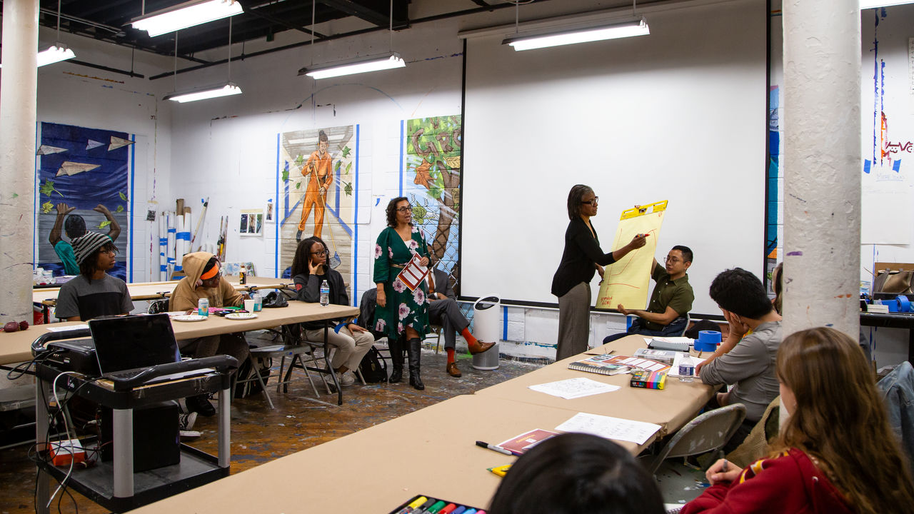 Group of people listening to presenter speak