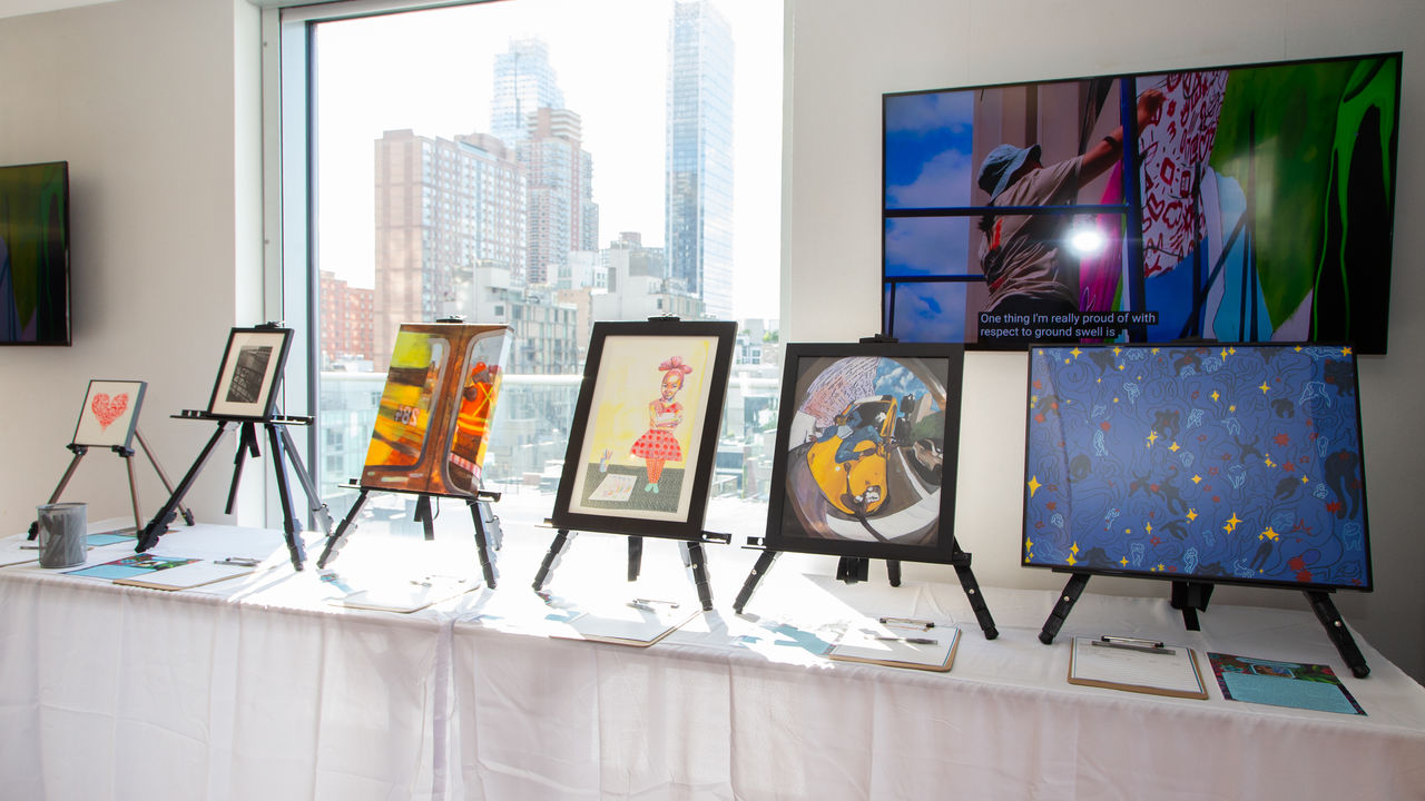 Table of framed artwork for art auction 