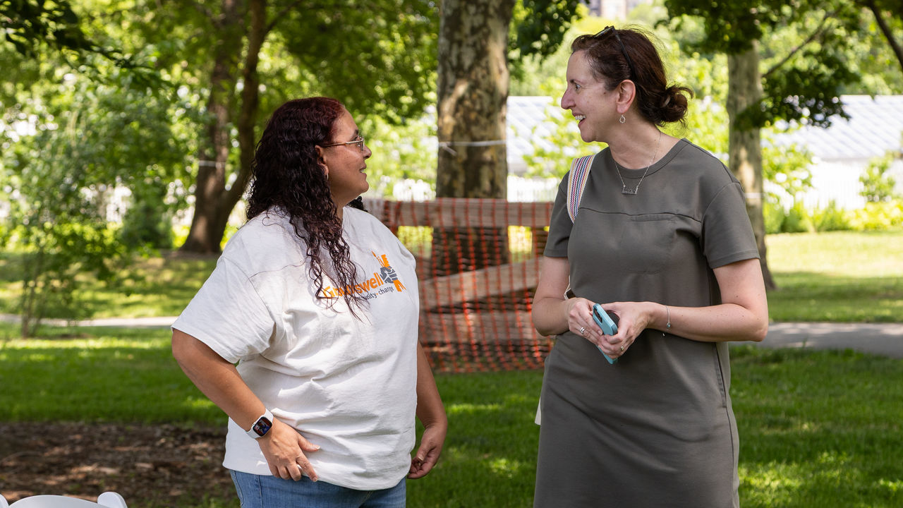 Two adults speaking to each other 