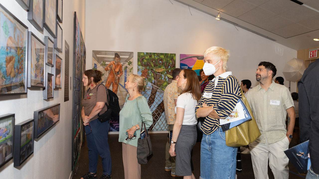 People looking at artwork in exhibition space